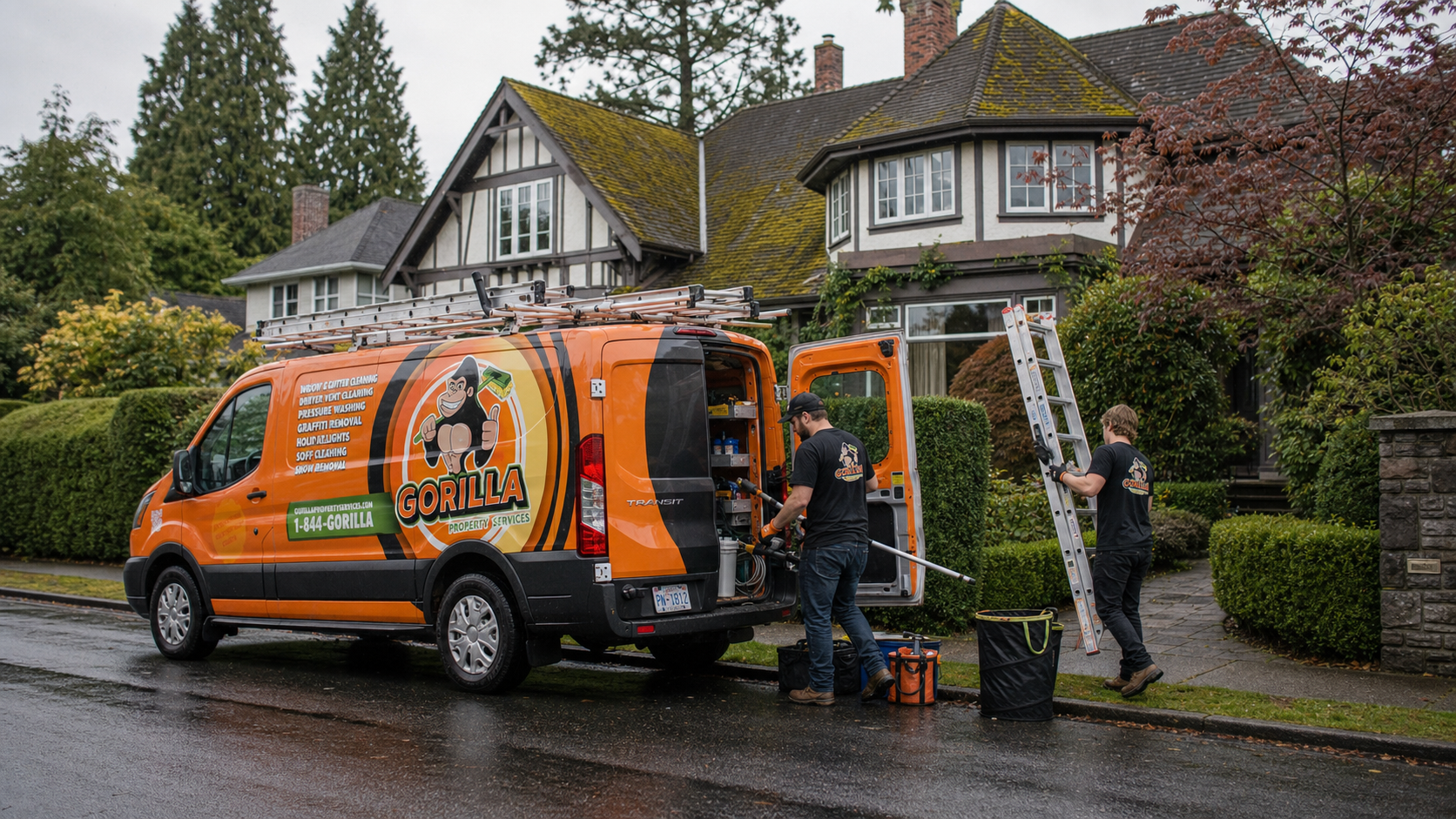 Roof moss removal crew unloading ladders and equipment beside an orange service van outside a mossy Oak Bay roof